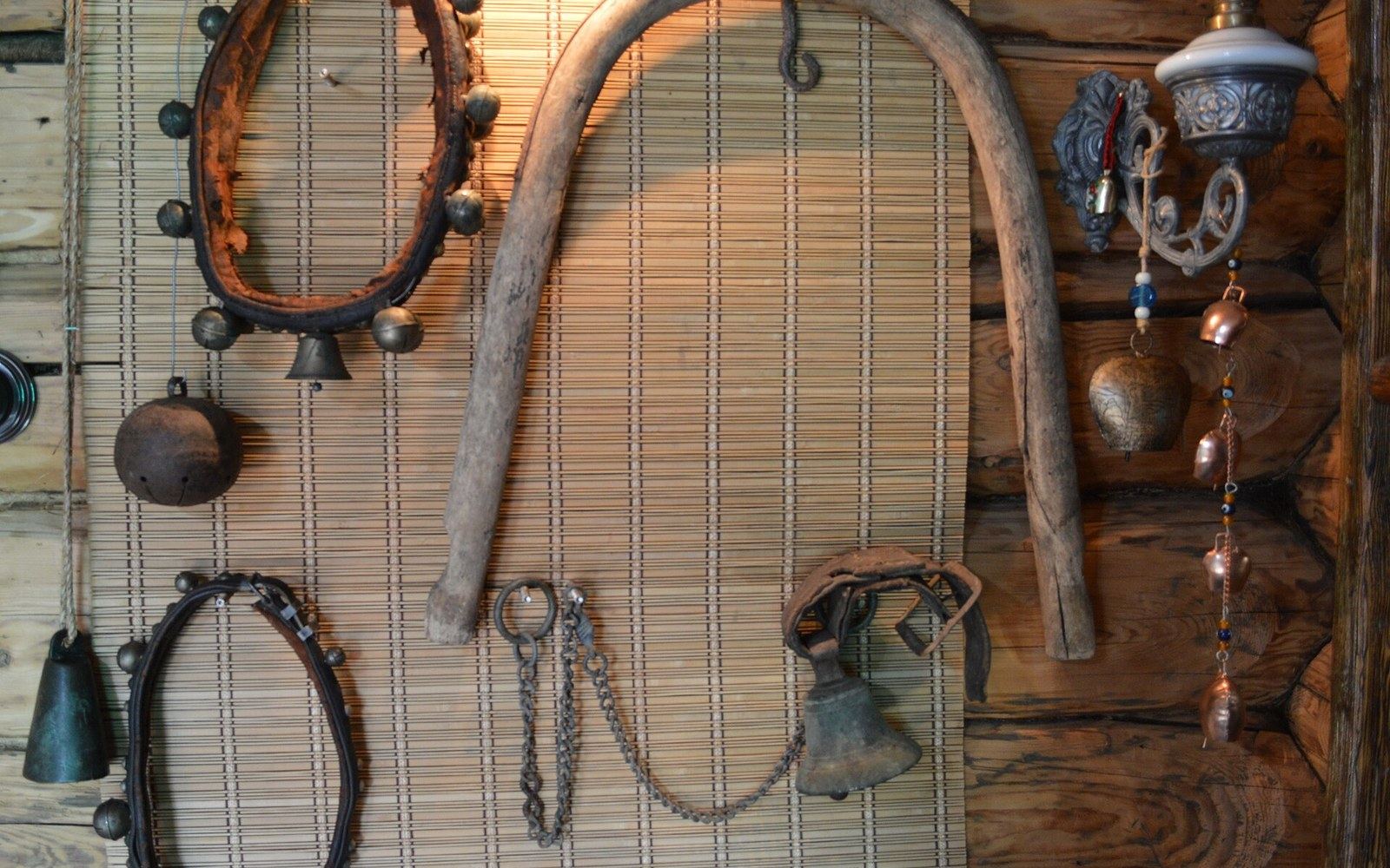 Harness bells, wooden collars and chain displayed on a museum wall